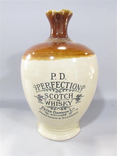 A Glazed Stoneware Ewer For P D Perfection Scotch Whisky By Peter