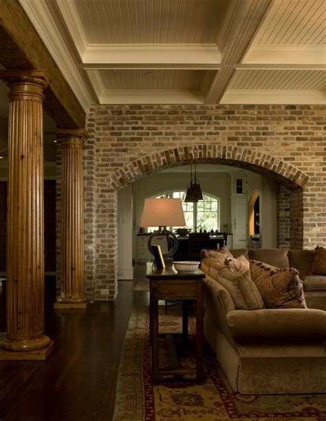 Living Room with Brick Arch, Natural Fluted Columns and Painted Wood ...