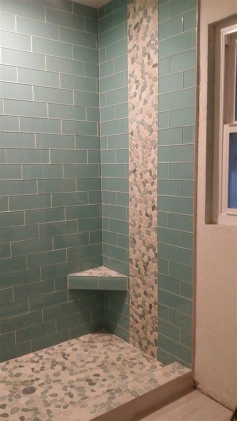 Stunning Shower Remodel Using Sliced Sea Green And White Pebble Tile As