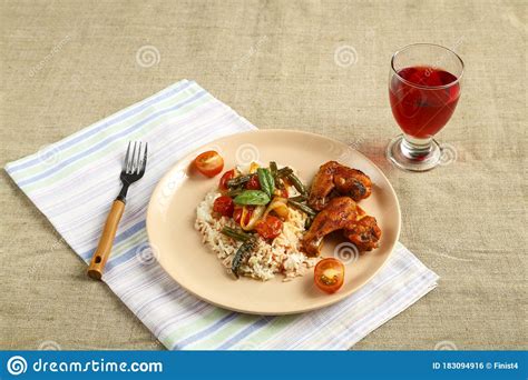 Asas De Frango Assado Em Molho De Tomate Arroz E Vegetais Em Uma