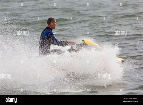 Man Riding Jetski In Poole Harbour In September Stock Photo Alamy