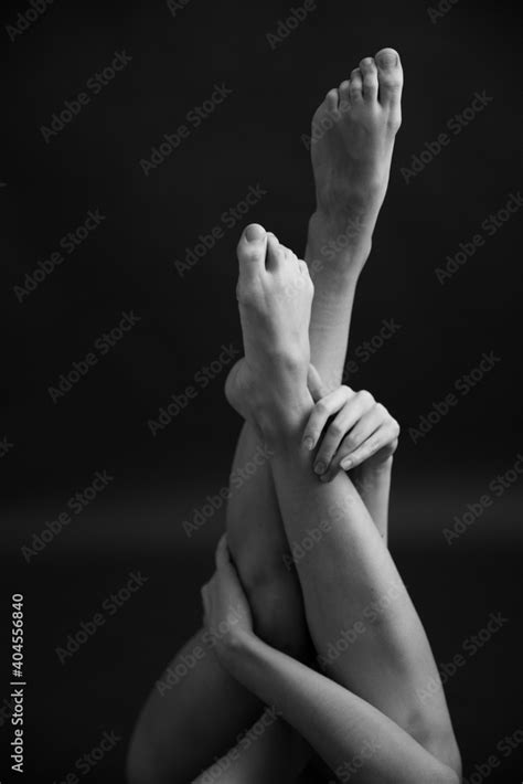 Black And White Photo Of Body Parts Geometry And Yoga Poses Of A Naked Female Body On A Dark