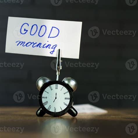 Alarm Clock And Banner With Handwritten Phrase Good Morning On Wooden