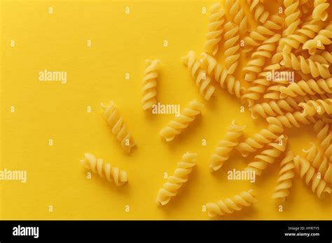 Fusilli Pasta Spirals On Yellow Background Stock Photo Alamy