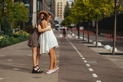 Happy Meeting Of Two Friends Hugging In The Street Stock Image Image