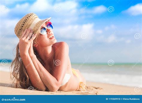 Woman In Bikini And Straw Hat Lying On Tropical Beach Stock Photo