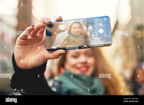 Sharing Her City Snaps A Young Woman Taking Selfies While Out In The