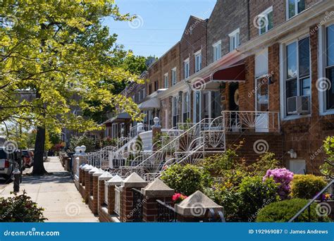 Row Of Old Brick Homes With Beautiful Spring Gardens In Astoria Queens