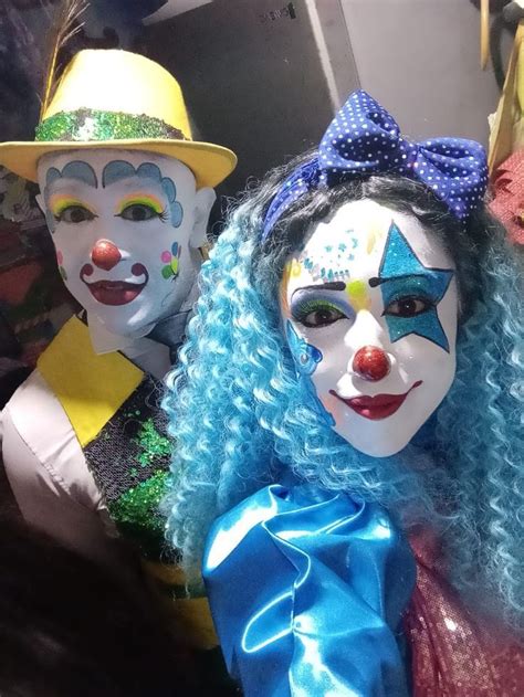 Three Clowns With Blue Hair And Colorful Makeup