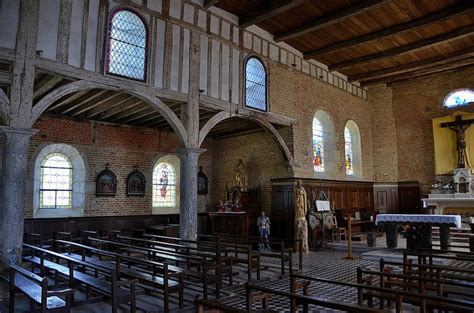 An Old Church With Pews And Stained Glass Windows