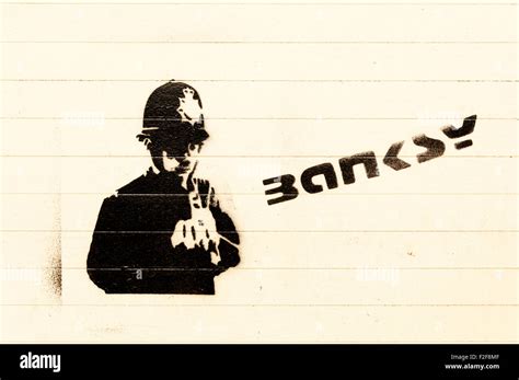 A Banksy graffiti of a policeman and signature on a wall in Lewisham ...