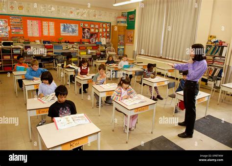 Grade 2 kids listening to their teacher in the classroom Stock Photo - Alamy