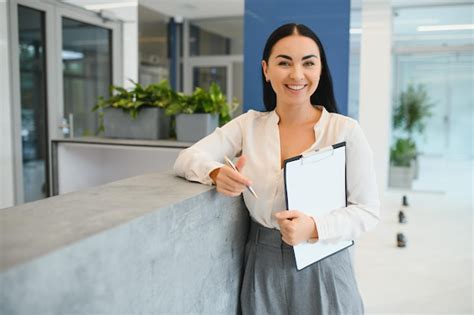 Premium Photo Portrait Of Beautiful Receptionist Near Counter In Hotel