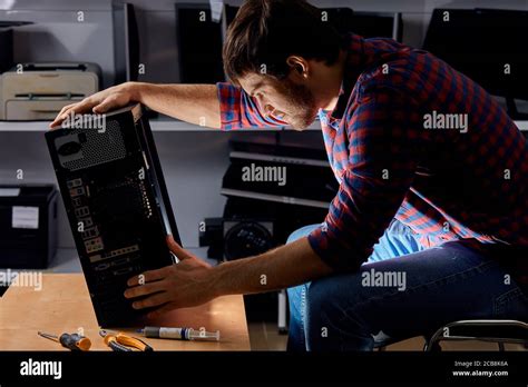 Talented Man Dealing With A Broken Computer Close Up Side View Photo