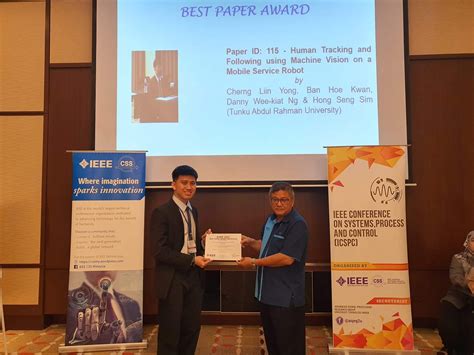 Yong Left Receiving The Best Paper Award Certificate