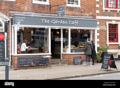 A Couple Looking In The Window Of The Garden Cafe An Artisan Bakery