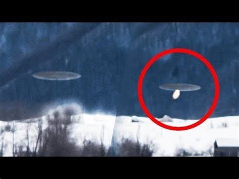 Two Flying Objects In The Sky With A Red Circle Over Them And Snow