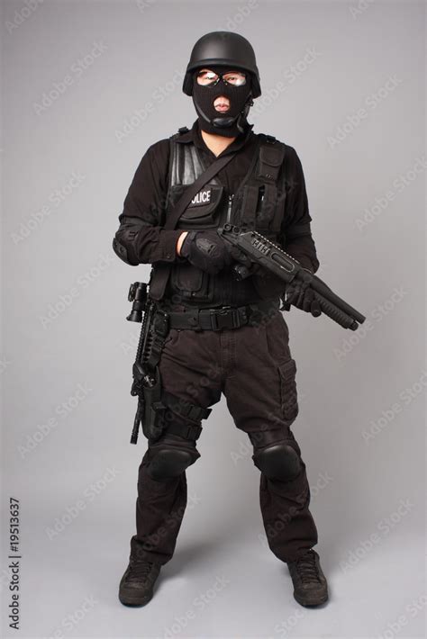 SWAT police officer with shotgun. Stock Photo | Adobe Stock