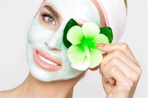 Beautiful Blonde Woman Model With A Green Facial Mask Beauty Spa Stock
