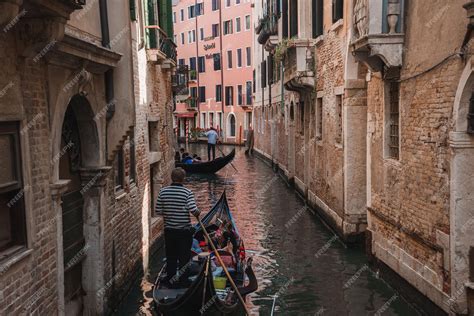 Premium Photo Serene Gondola Ride Through Traditional Venetian Canal