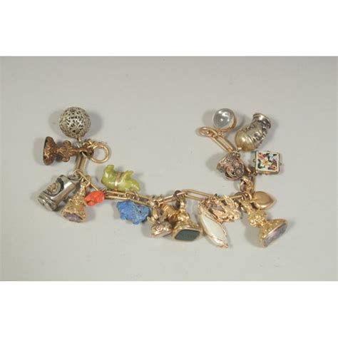 A 9ct Gold Charm Bracelet Set With 20 Various Charms