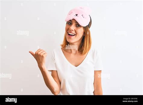 Beautiful Redhead Woman Wearing Sleeping Mask Over Isolated Background