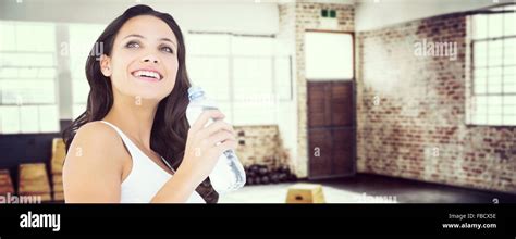 Composite Image Of Pretty Brunette Drinking Bottle Of Water Stock Photo
