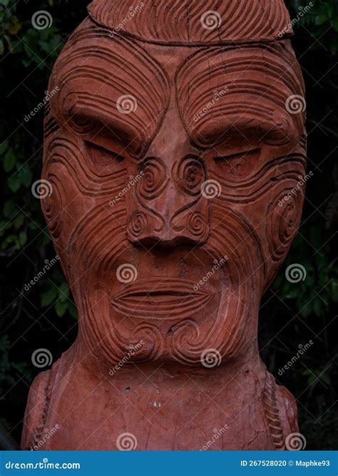 Close Up Of Traditional Red Wooden Maori Sculpture Figure In Abel