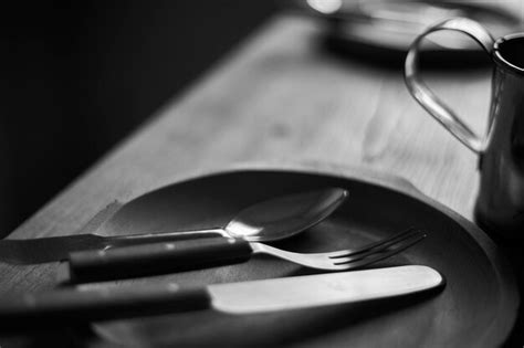 Premium Photo Trio Spoon Fork And Knife In The Wooden Plate Defocused