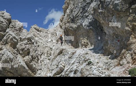 Tourist With Equipment On The Via Ferrata Trail In The Dolomites