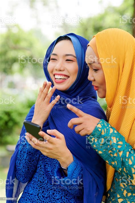 Laughing Muslim Women With Smartphone Stock Photo Download Image Now