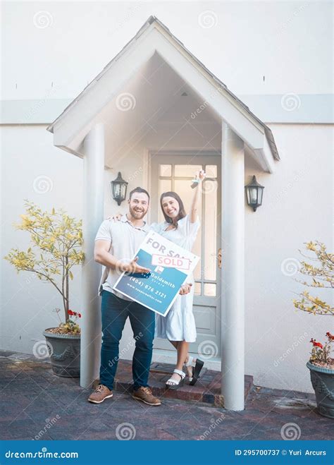 Couple Buying a House Together. Couple Holding Keys in Front of Their
