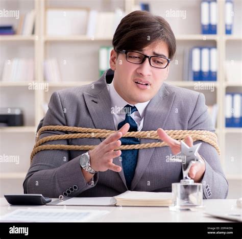 The Businessman Tied Up With Rope In Office Stock Photo Alamy