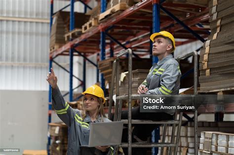 Male And Female Warehouse Worker Working And Inspecting Quality Of