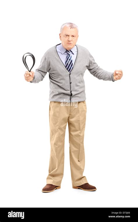 Full Length Portrait Of An Angry Mature Man Holding A Belt And Looking