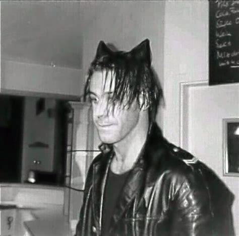 Black And White Photograph Of A Man Wearing A Leather Jacket With Cat