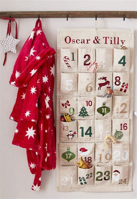 A Towel Hanging On A Wall Next To A Calendar And Christmas Tree Ornament