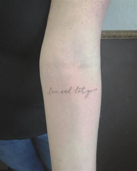 Fine Line Style Tattoo On The Left Forearm Saying Live And Let Go