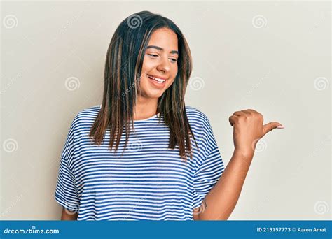 Joven Latina Con Ropa Casual Apuntando El Pulgar Hacia El Lado Sonriendo Feliz Con La Boca