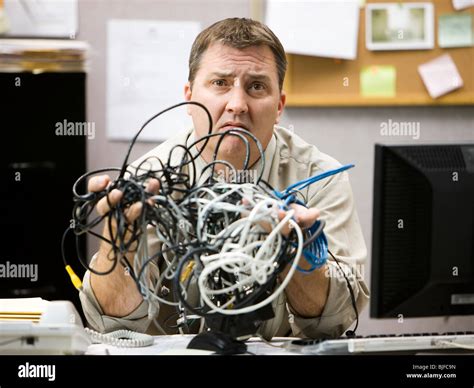 Man Trying To Figure Out Computer Wiring Stock Photo Alamy