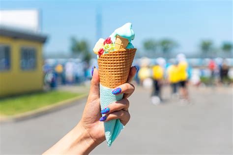 Premium Photo Melted Ice Cream From The Hot Summer Weather In A Woman Hand On The Background