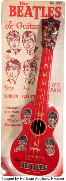 A Red Ukulele With The Beatles Sticker On It S Back Side