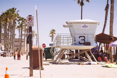beach premises featuring lifeguard hut palm trees a resting man and