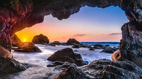 Epic Sunset From A Sea Cave Wallpaper Backiee