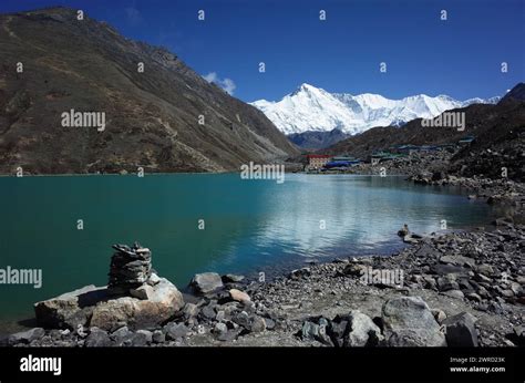 Stone Pyramid Next To Sacred Gokyo Lake With View Of Gokyo Village And