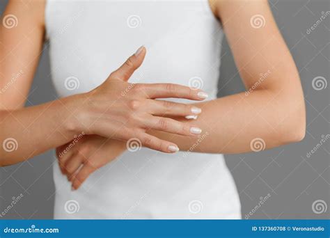 Closeup Shot Of Woman Hands Holding Cream And Applying Moisturizing