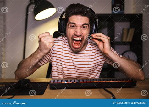 Screaming Angry Gamer Playing Video Games On Computer Stock Photo