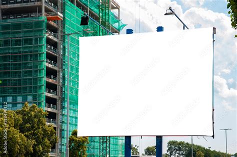 Advertising Billboard Mockup In Front Of Construction Site Of Modern