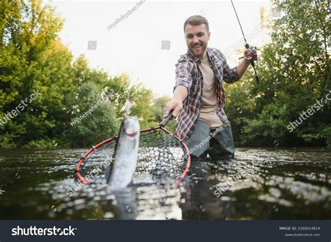 man catching  fish   royalty  licensable stock