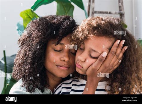 Mother Consoling Sad Daughter Stroking Her Cheek Stock Photo Alamy